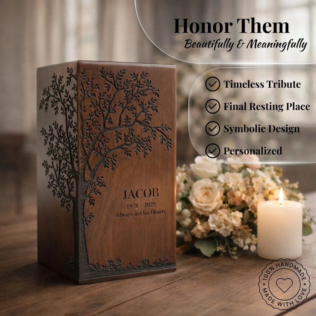 Wooden urn with engraved tree design and personalized text, placed on a wooden surface with flowers and a candle in the background.