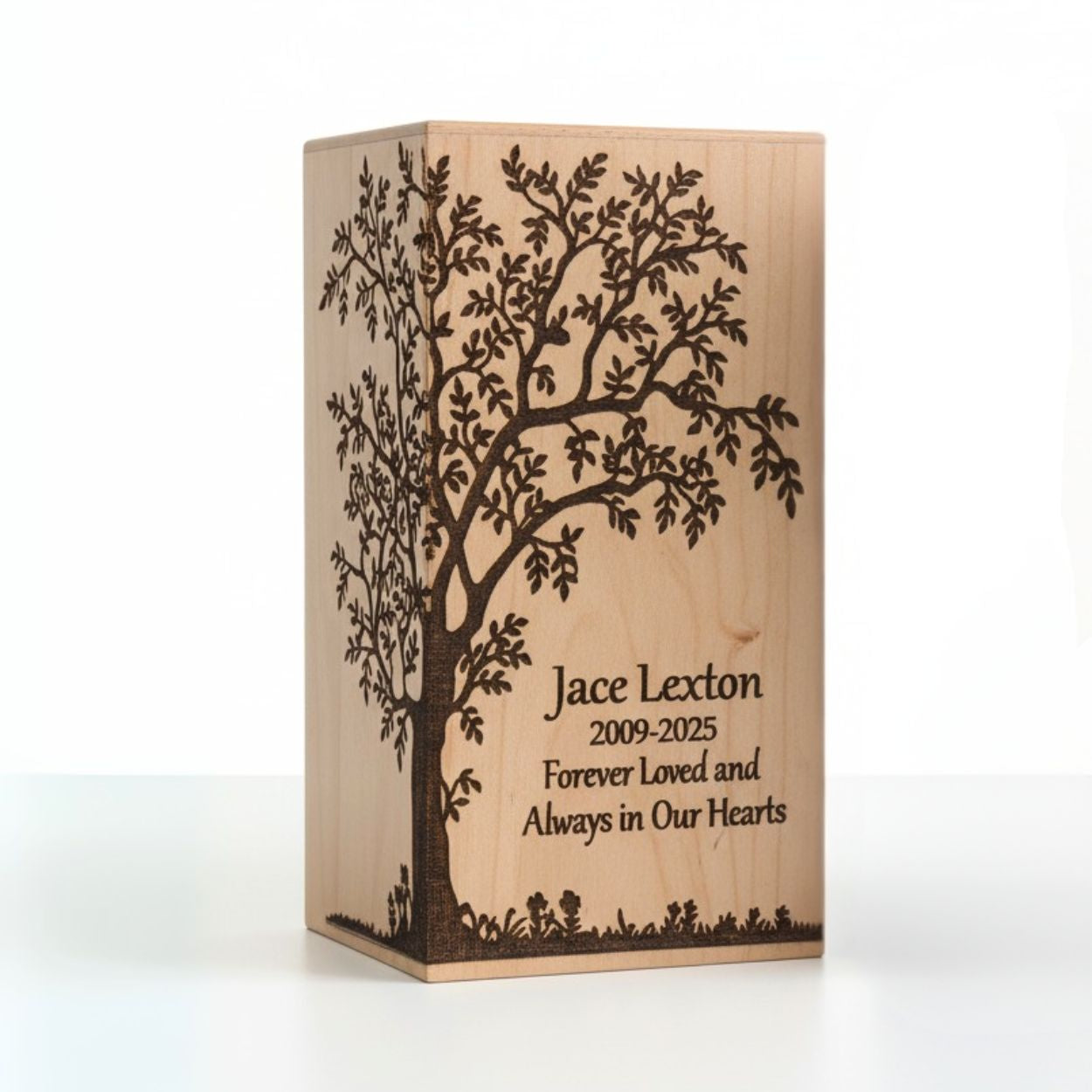 Wooden urn with engraved tree design and text on a white background